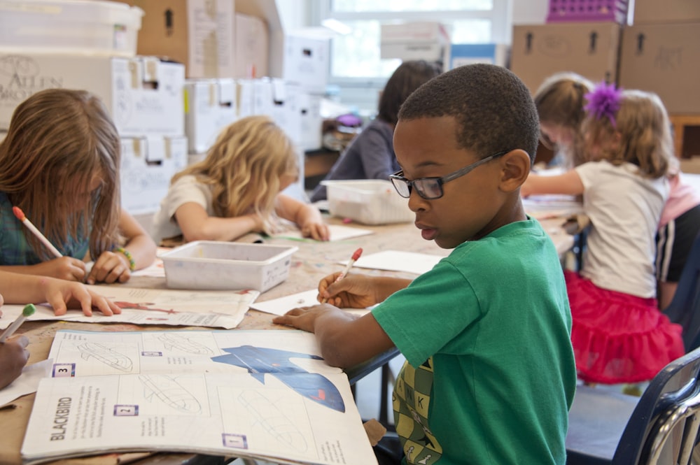 Children writing at school before getting a doctor’s note online