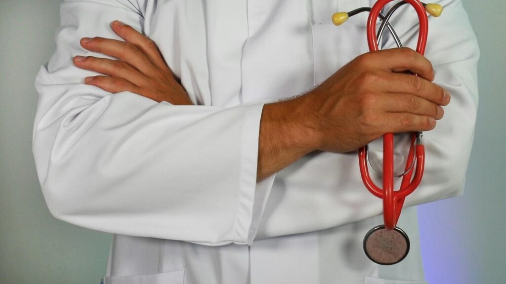A doctor wearing a lab coat and holding a stethoscope