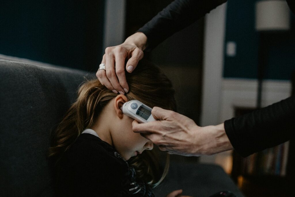 a woman using a digital thermometer