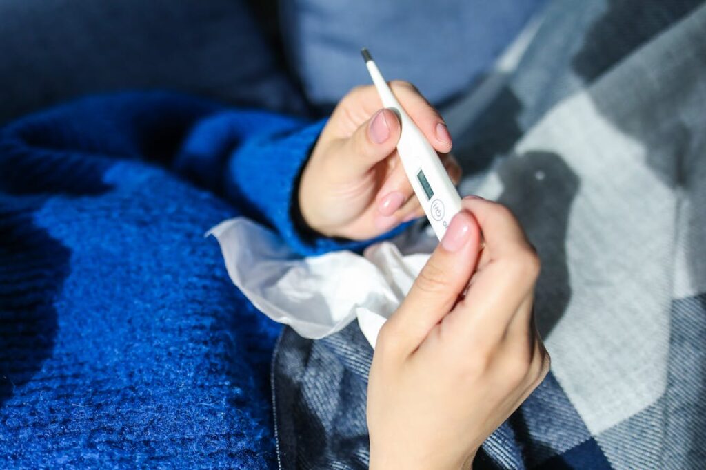 A person holding a thermometer