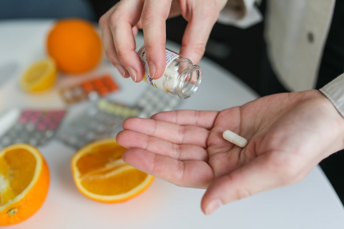 A person taking medication out of a bottle