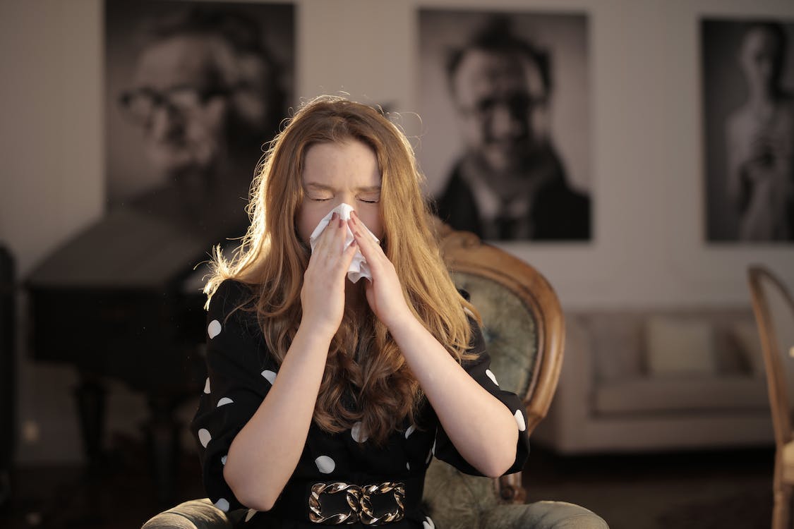 A woman blowing her nose