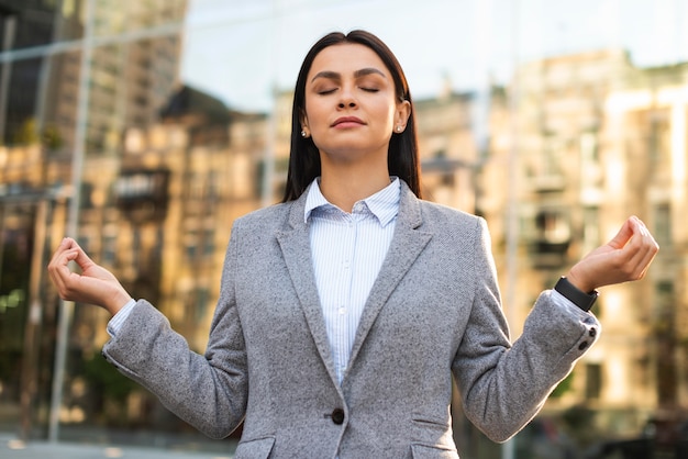 A businesswoman taking a deep breath