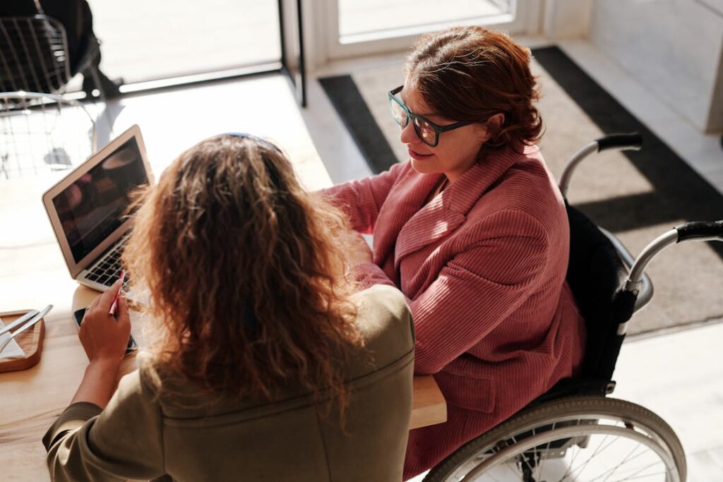 Two women working on a laptop