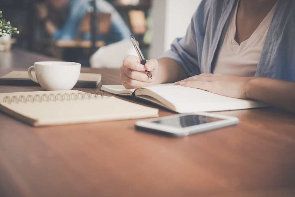 Student with a notebook, teacup and a tablet