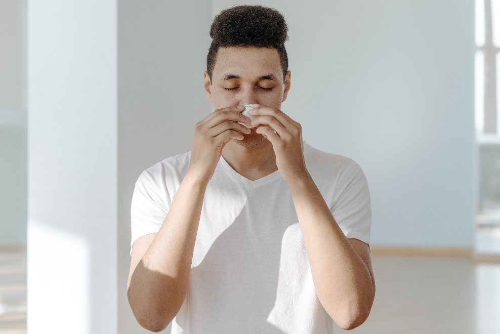 Man wiping his nose