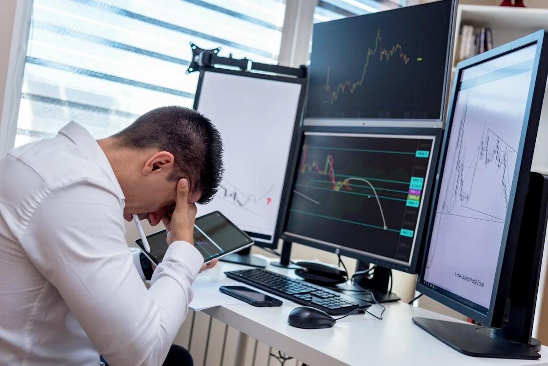 A worker looking stressed at their desk