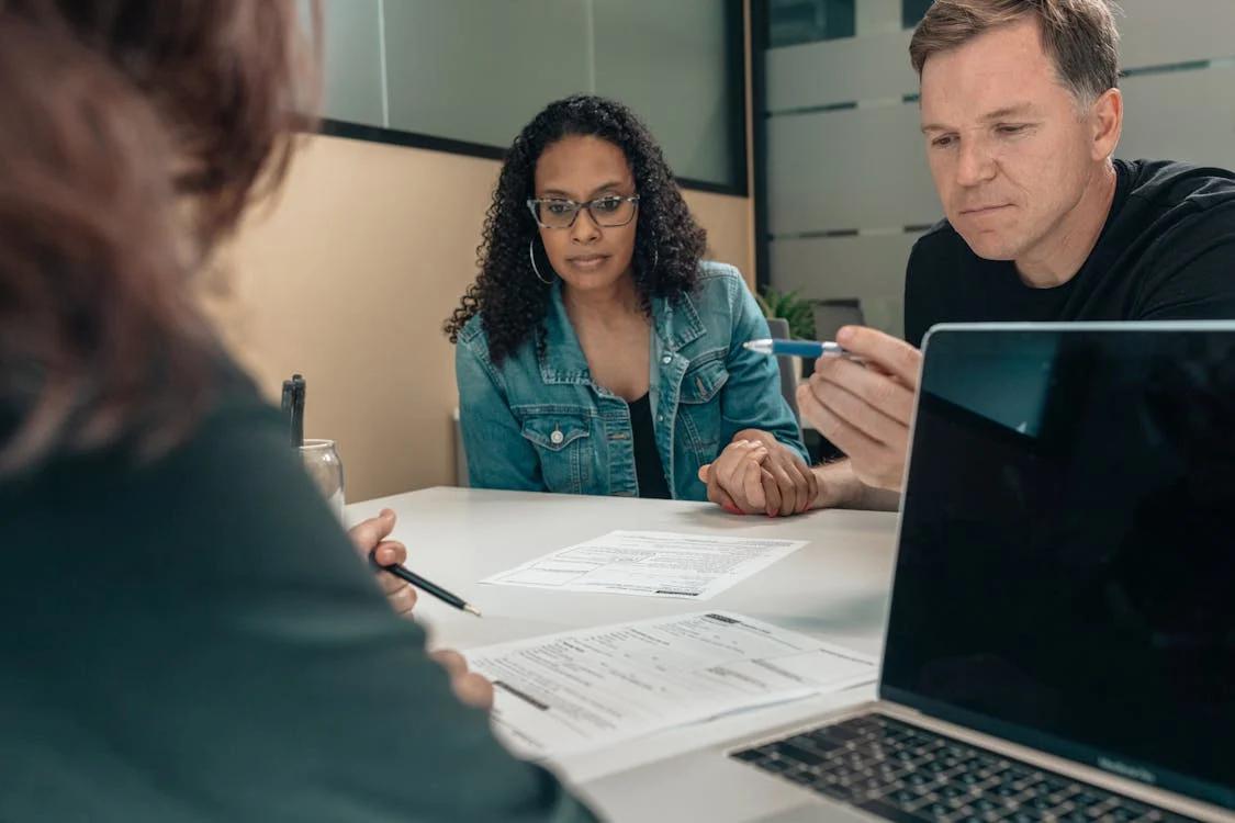 Two colleagues having a discussion at a desk