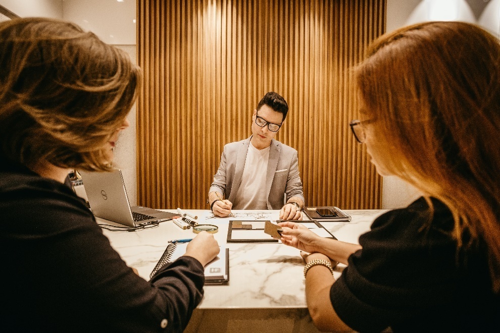 A trio of people in a meeting