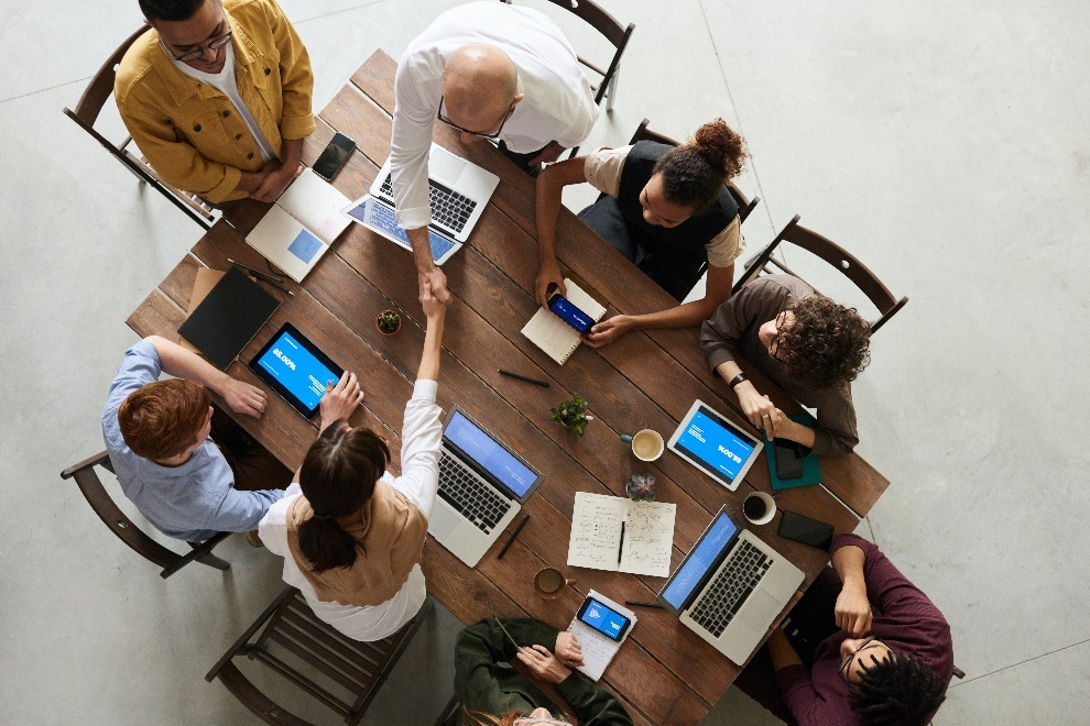 People working on laptops at a table 