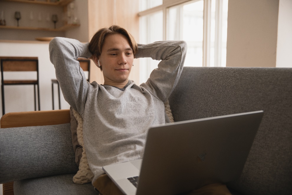 Man wearing AirPods looking at a laptop