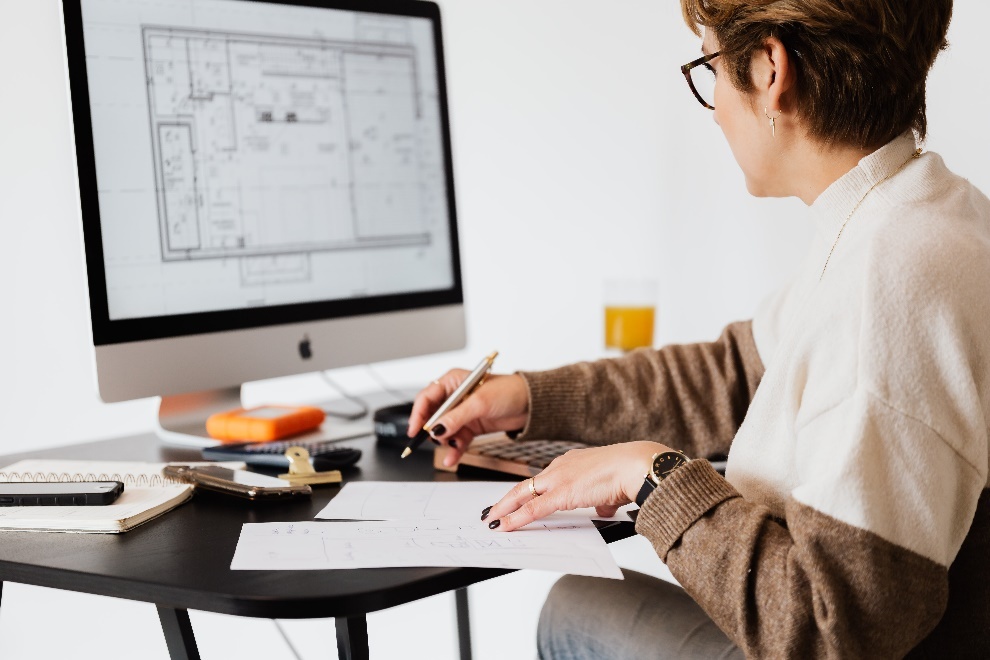 Notebook, pen, and a desktop on a table