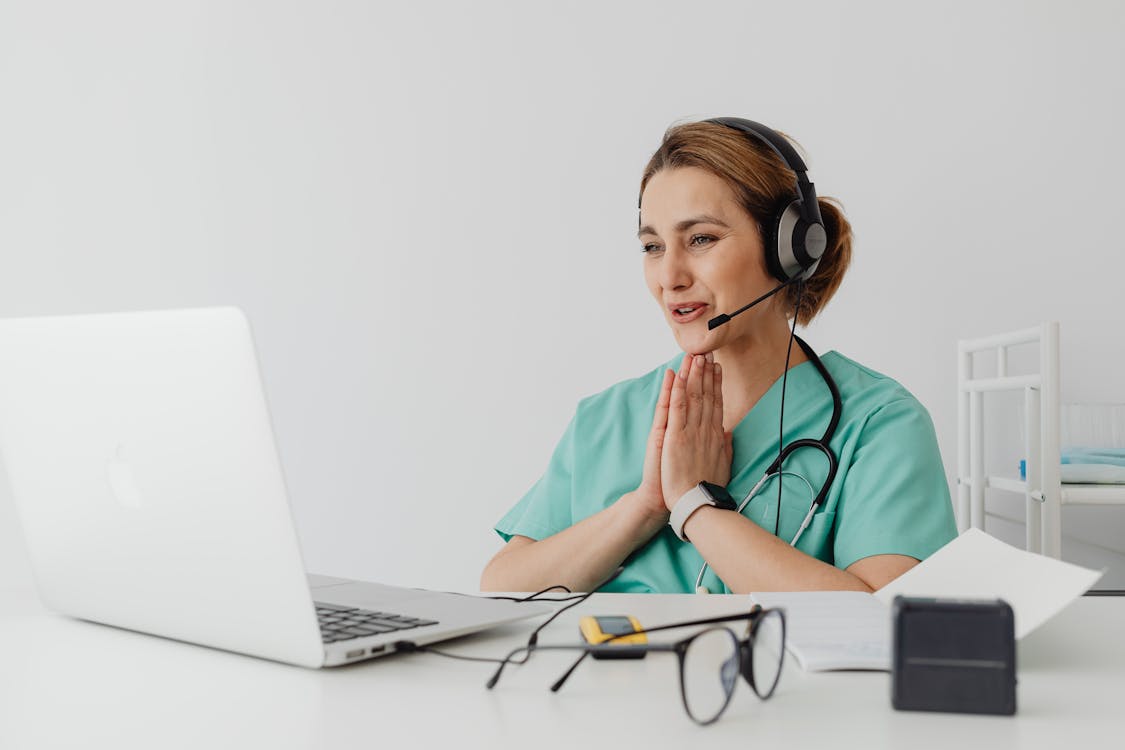 A doctor in front of a laptop