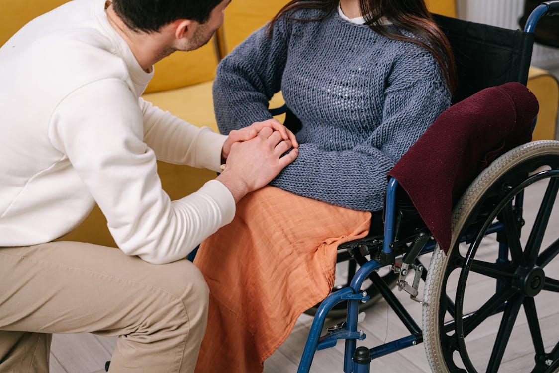 A man holding a woman’s hands 