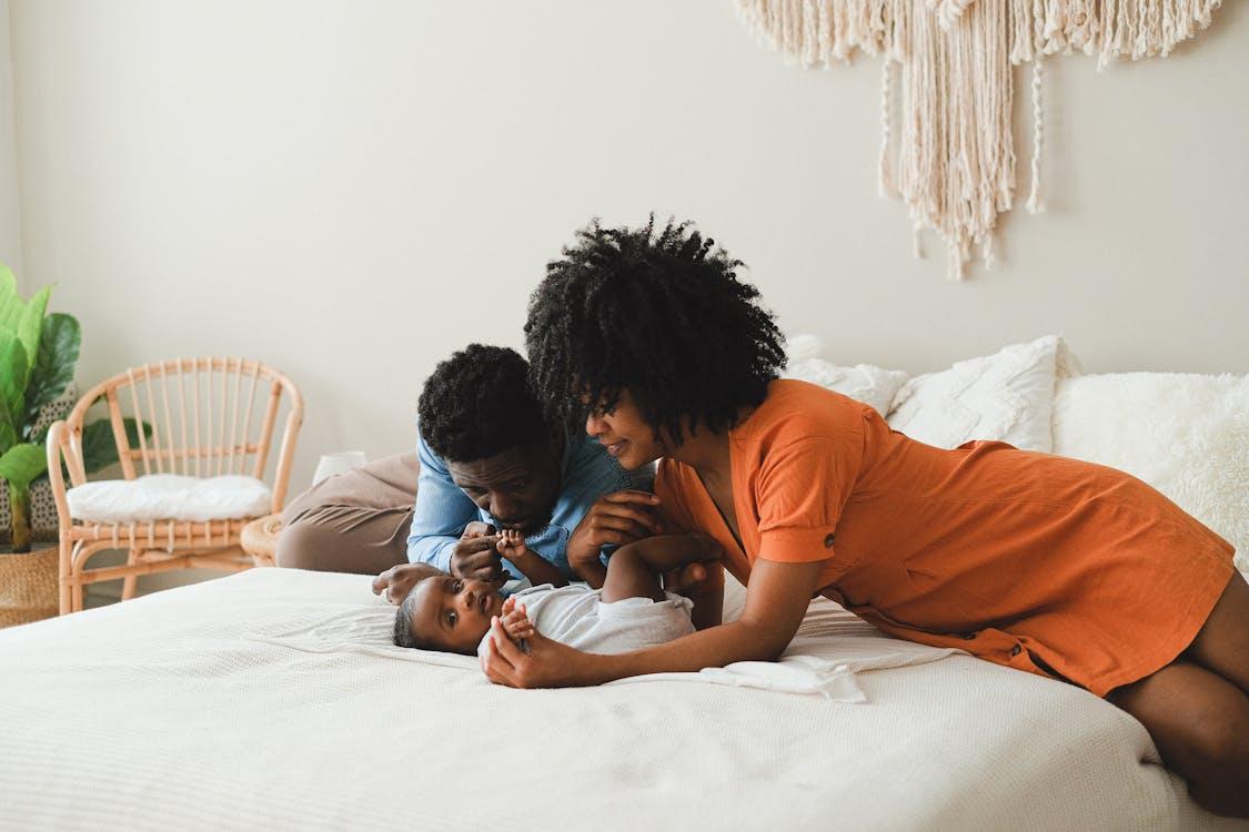 A man and woman taking care of their baby 