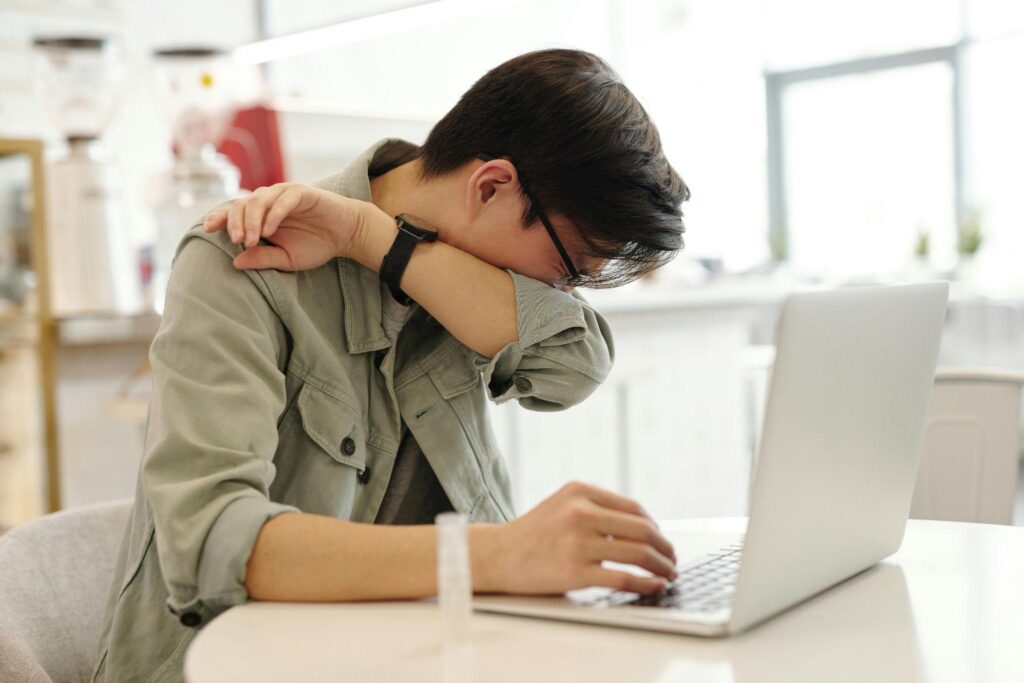 A male employee sneezes.