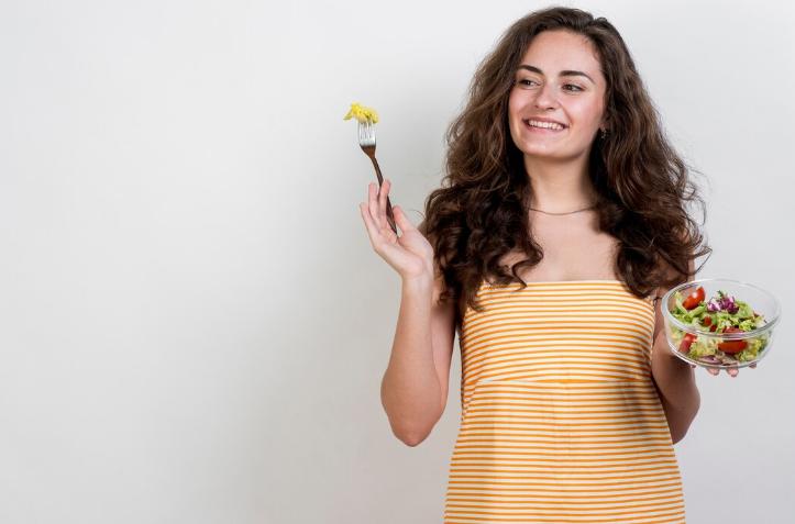 Woman holding a bowl of salad 