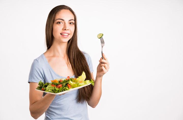 Woman holding a tray of healthy food 