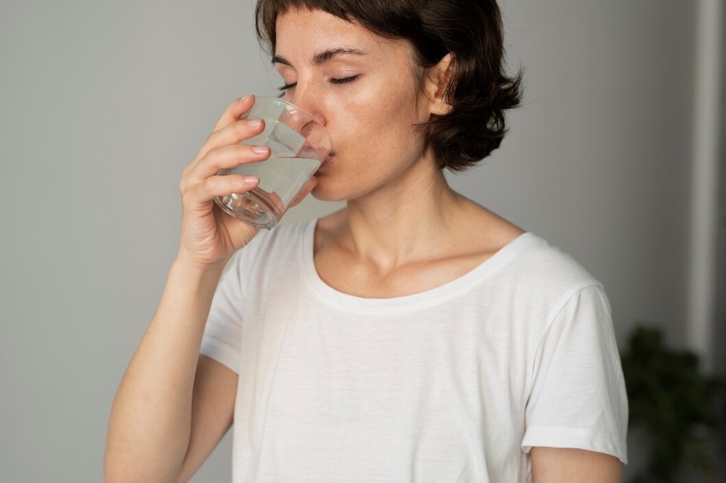 Woman drinking a glass of water 