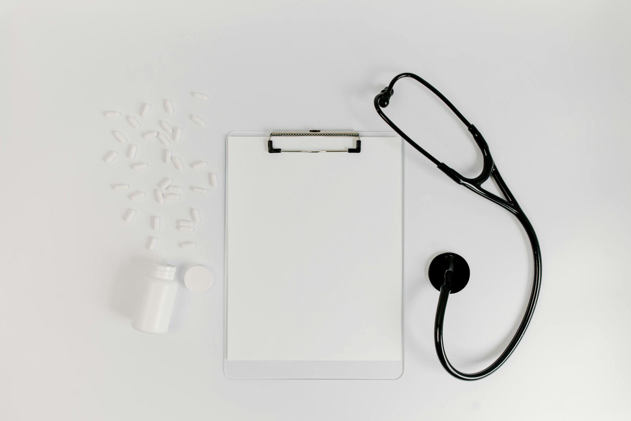 Clipboard and black stethoscope used for medical consultation