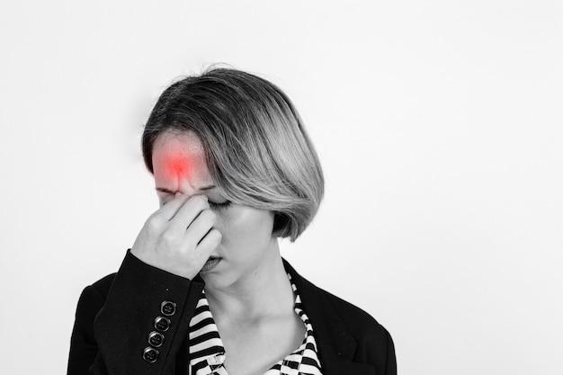 A woman holding her head in discomfort