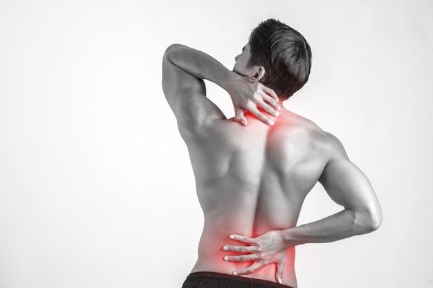 A close-up of a man rubbing his painful back.