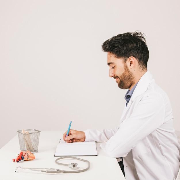 A smiling doctor sitting at a desk