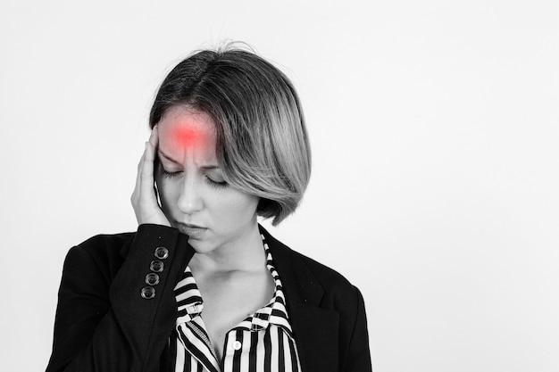 A businesswoman touching her head with her hand.