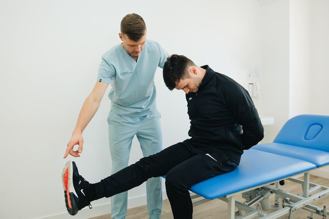 A physiotherapist guiding a patient through an exercise