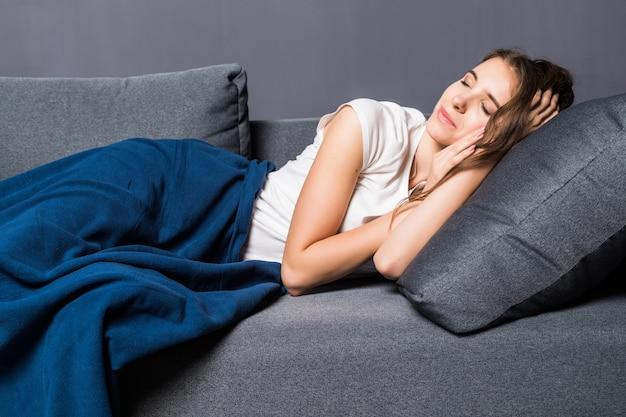 A young woman sleeping on a sofa.