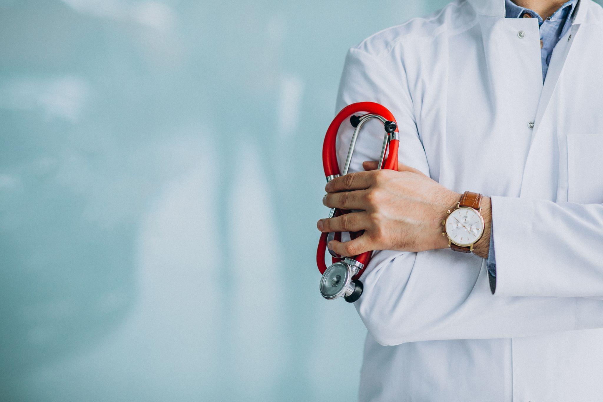 A doctor standing with arms crossed and a stethoscope.