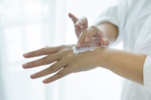 A person applying ointment. 