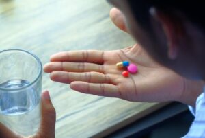 Person taking medication for skin infection.
