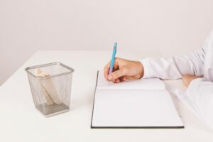 A person writing a sick note 