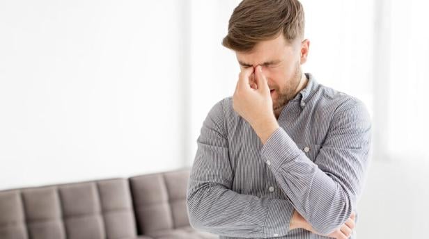 A man experiencing a headache. 