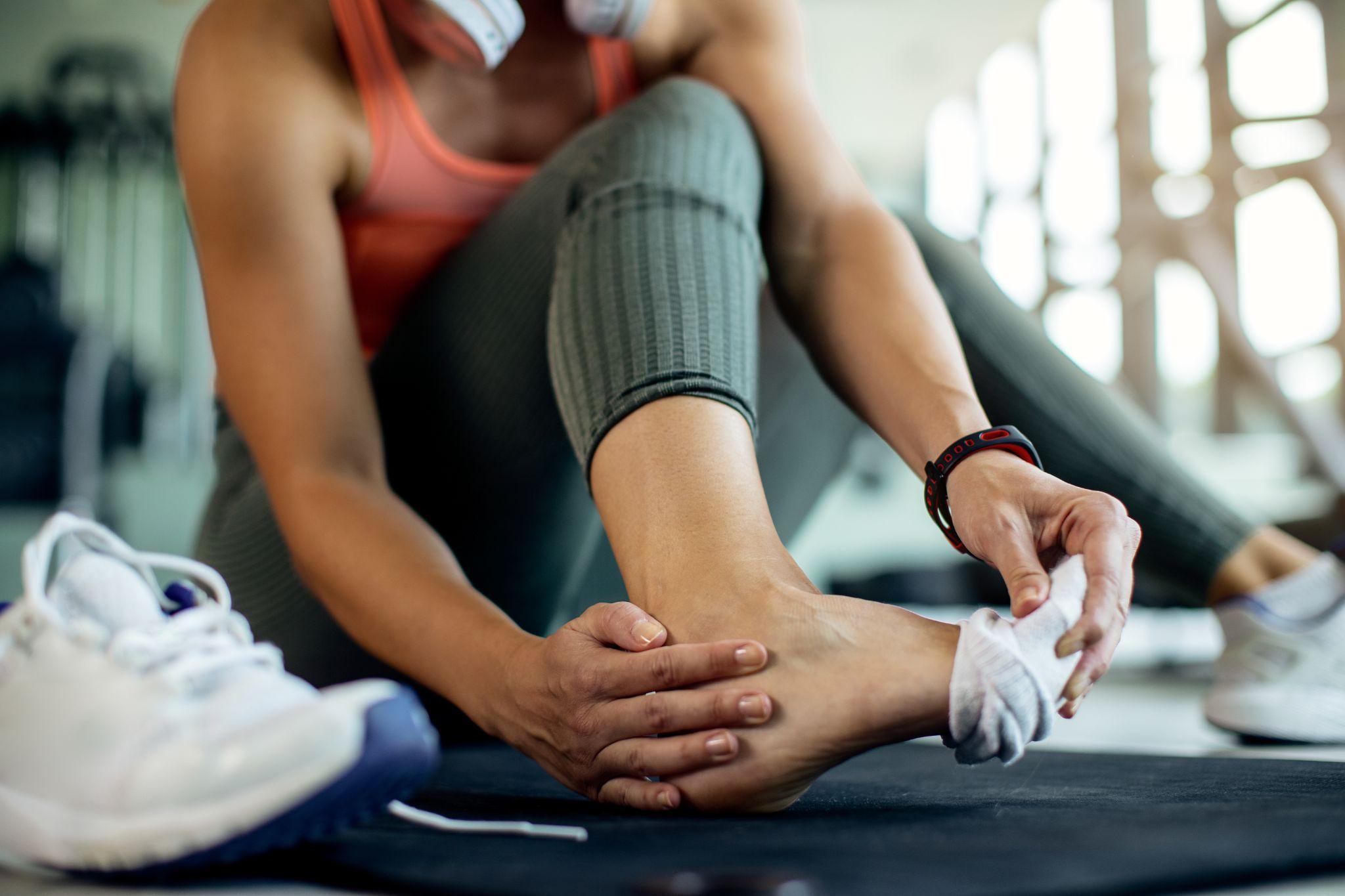Woman holding her heel in pain 