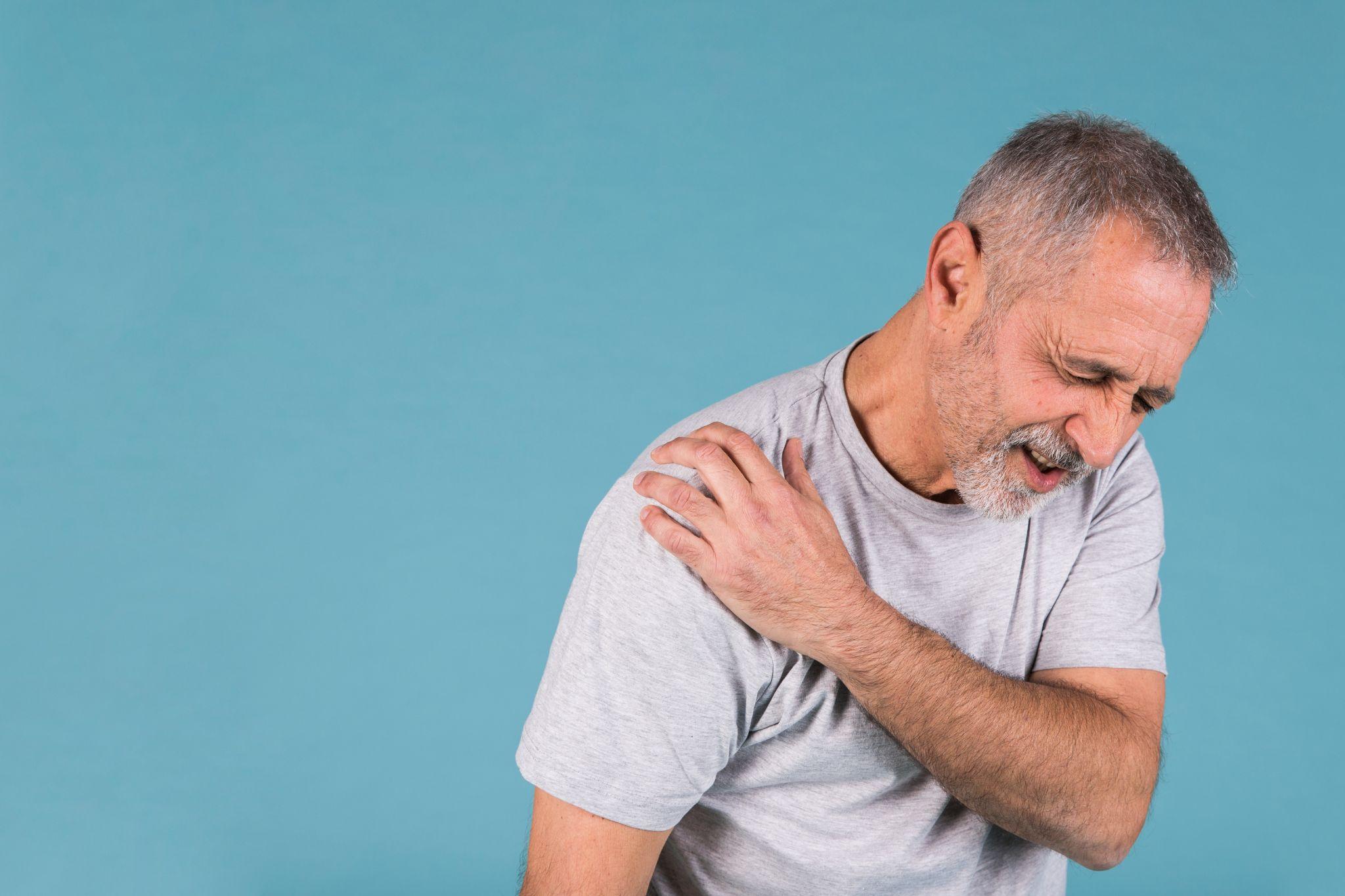 Person clutching shoulder in pain from labral tear