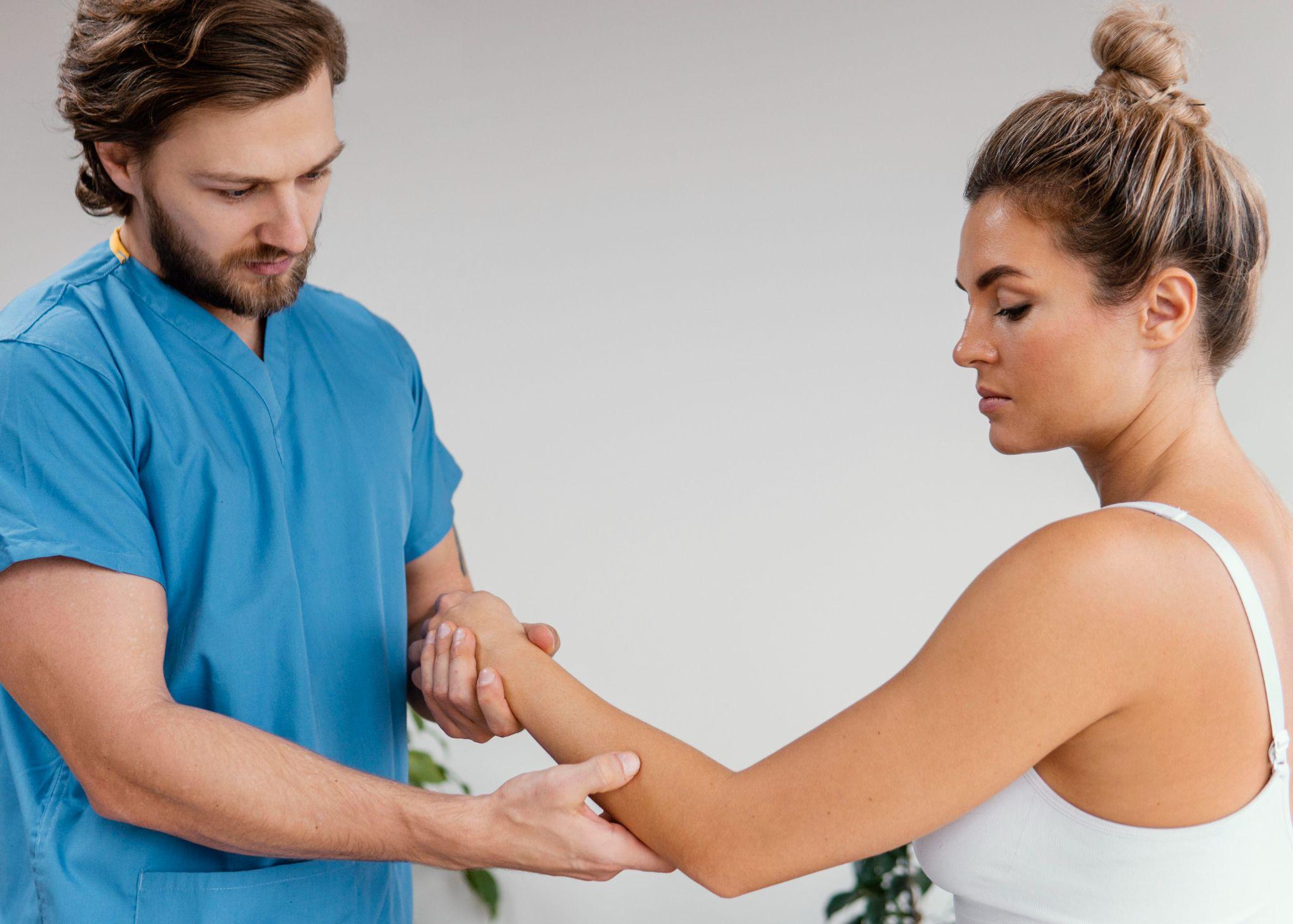 Physical therapist examining a patient's wrist and arm