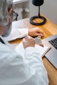 elderly doctor writing a prescription