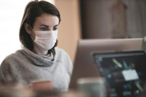 A woman wearing a face mask at work
