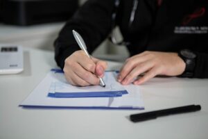 A male doctor writing a doctor’s note