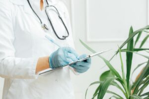 A picture of a doctor writing on a notepad