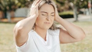 a woman holding her head