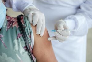 A woman getting a vaccine.