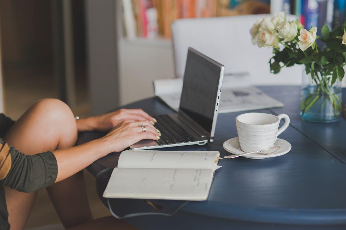 A person using a laptop for an online doctor’s note