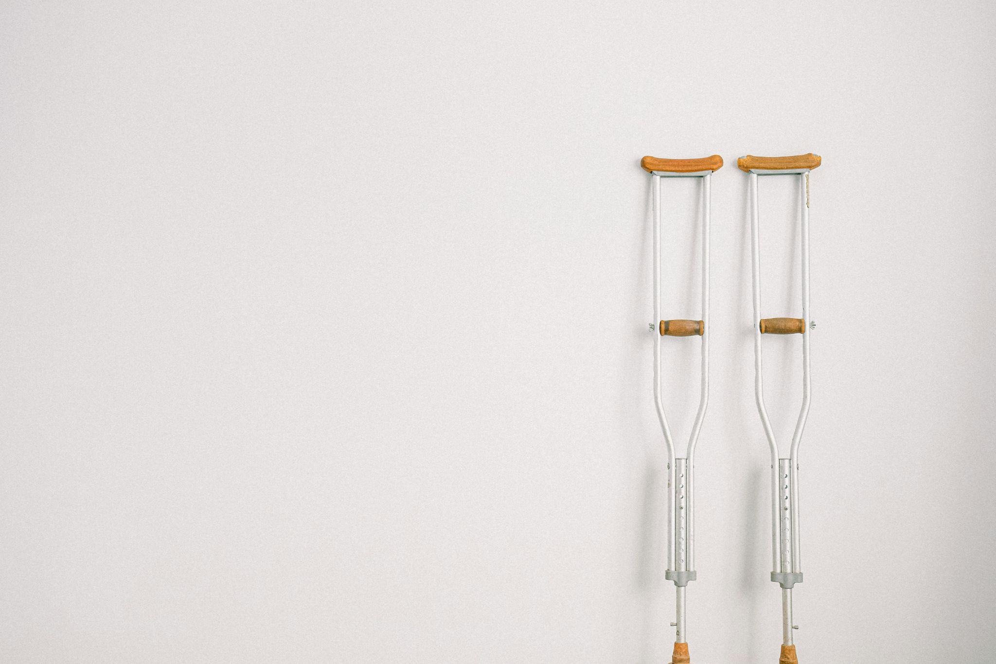 pair of crutches standing against a wall