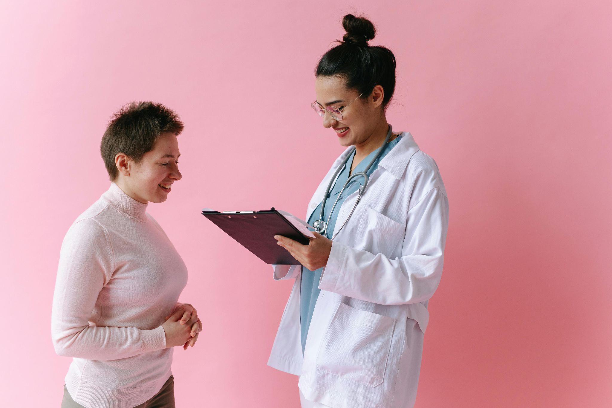 doctor holding a clipboard while speaking with a patient