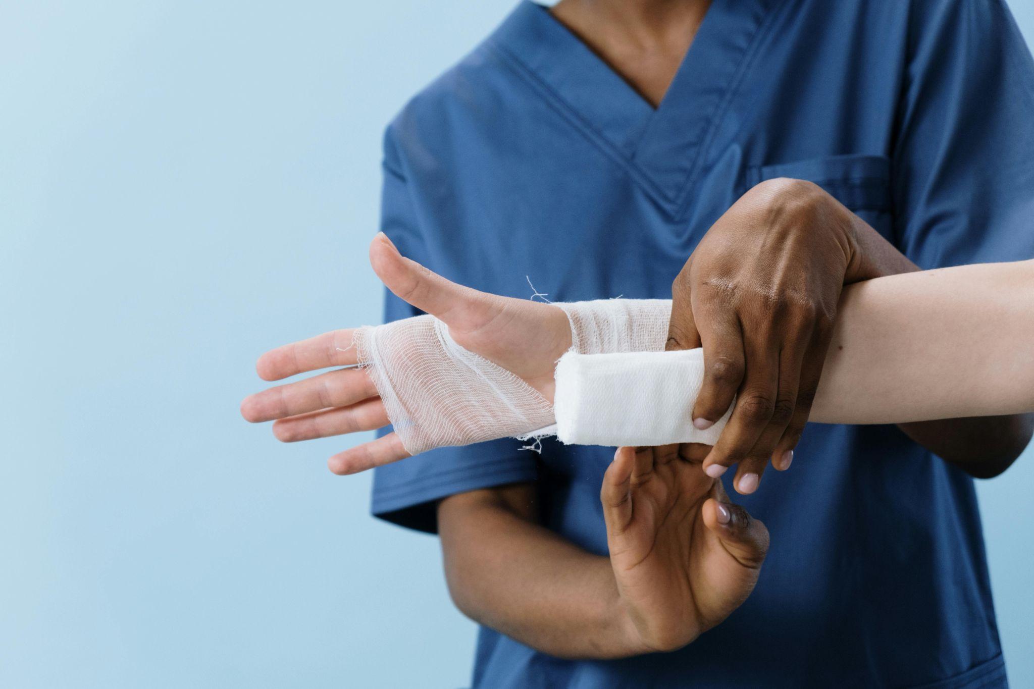 healthcare worker applying a bandage to an injured wrist