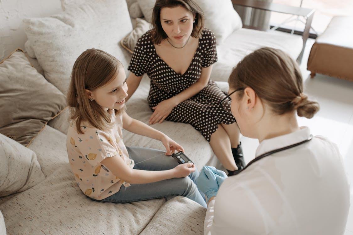 a doctor checking a child for symptoms.