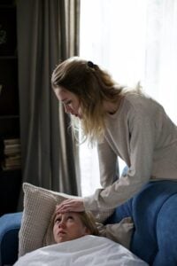 a woman sitting with her sick child. 
